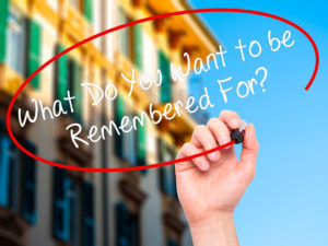 52694071 - man hand writing what do you want to be remembered for? with black marker on visual screen. isolated on city. business, technology, internet concept. stock photo